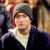 Static 50x50 pixel icon showing a person with light skin, dark hair, and a white beard wearing a gray hat and dark clothing against a blurred background.
