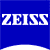 Blue background with white pixelated text 'ZEISS' centered horizontally, bottom edge curves upward into a white arc.
