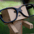 A pixelated cartoon character with glasses appears in multiple scenes: reading a book, holding a pen, and standing against green grass.