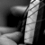Grayscale pixelated image of a figure in motion with blurred limbs and diagonal lines suggesting rapid movement against dark background.