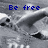 Pixelated grayscale image with blue text 'Be free' overlaid on abstract shapes and scattered black dots.