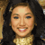 A pixelated image shows a person with long dark hair and light skin wearing a gold necklace, next to a golden 'The Suite Life' logo with colorful fish graphics and '@Disney' text.