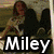 Four- of pixelated images with text overlays: top-left shows a figure with dark hair, top-right displays 'nick' text over a person, bottom-left reads 'Miley + Nick', bottom-right shows 'Best friends 4 life' text over a couple