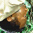 A pixelated image shows a person with light hair and dark clothing lying on green foliage, next to a large metallic object, with an orange banner reading 'the rundown' at the bottom right.