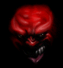Red-skinned demonic face with sharp teeth and glowing eyes in three vertical showing sequential expression changes