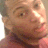 Pixelated close-up of a person's face with light skin tone, brown eyes, and dark hair visible on the left side.