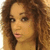 A person with curly brown hair and light skin appears in four showing slight head movement and mouth position changes