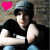 Pixelated image of a person wearing dark clothing and light blue pants, with a bright pink heart symbol in the top-left corner.