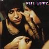 A static image shows a person in a black sleeveless shirt with a hand near their face, and text reading "PETE WENTZ." in the top-right corner.