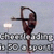 Pixelated image of a figure in a dynamic pose with a raised arm, standing before a blurred background with indistinct text elements.