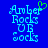 Pixelated blue text on a solid blue background with one version featuring a green heart symbol above the 'r' in 'Amber'.