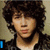 A four- shows a person with curly brown hair in different poses, each containing blue text on black backgrounds