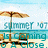 Pixelated beach scene with umbrella, chairs, and water under a light blue sky, featuring partially visible text.