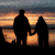 Silhouettes of two figures holding hands against a sunset sky with horizontal orange and blue bands.