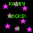 Black background with scattered pink stars and green text reading 'KASEY' and 'ROCKS!' in pixelated font, plus two '=]' smiley faces.