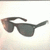 A pair of dark gray sunglasses with a curved frame appears on the left side of a light background, while black text 'lol syd' is positioned to the right.