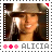 Alicia Keys wearing a brown hat with long dark hair, smiling with visible teeth, in a pixelated stamp-style frame with pink and red dots and 'ALICIA' text below.