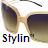 Pixelated image of dark sunglasses with light brown frames and a stylized 'Stylin' text below, set against a white background.