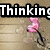Animated icon with pink smoke-like shapes rising against a wooden background, displaying text fragments 'Thinking', 'About', and 'You' in bold white letters.