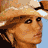 A 48x48 pixel animated contact sheet showing three sampled frames of a woman with blonde hair wearing a light brown cowboy hat, displayed in a 2x2 grid layout with one empty gray cell.