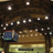 A pixelated static image shows a dark wooden interior with multiple small square lights arranged in rows above a brown counter, a blue and red object on the left, and a yellowish lower section.