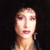 Pixelated close-up of a person's face with light skin, pink lips, and dark hair against a black background.