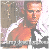 Pixelated image of a shirtless man with a white jacket draped over his shoulders, standing against a blurred background with text at the bottom.