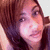 A pixelated close-up of a person with brown hair and light skin, showing two side-by-side views where the right view includes a black heart symbol near the lower center.