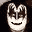Pixelated cartoon face with white mask-like features, brown hair, and two distinct mouth expressions against a dark background.
