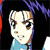 Pixelated cartoon-style face with light skin, brown eyes, and short brown hair, wearing a light blue top against a black background with purple and red accents.