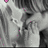 Pixelated grayscale image with scattered pink dots, featuring abstract shapes and no discernible figures or text.