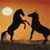 Two dark horses rear on hind legs against a gradient sunset sky with a large pale sun, their manes flowing and hooves raised in dynamic motion.