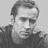Static grayscale buddy icon of a person with short hair and dark clothing, rendered in low-resolution pixel art style on light gray background.