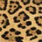 Static pixelated image of a leopard skin pattern with irregular dark brown and black spots on a light tan background.