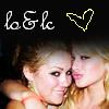 Two women with blonde hair pose closely together, one with eyes closed and the other looking at the camera, under white text and a heart symbol.