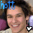 A pixelated image of a person with dark hair wearing headphones, smiling broadly across where heart symbols change color