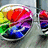 Pixelated rainbow-colored icon with a red heart shape, blue and purple elements, green and yellow accents on the left side.
