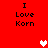 Red background with black text "I Love Korn" repeated in four positions and two pixelated heart symbols, one white and one pink.