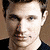 Two side-by-side pixelated portraits of a man with light brown hair, one showing him facing forward and the other turned slightly right.