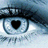 Pixelated eye with heart-shaped pupil, black eyeliner, and blue-gray tones on a light background.
