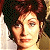 A pixelated buddy icon featuring a person with dark curly hair on the left and green text reading "Original Icons .com" on a solid green background to the right.