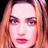 Static 48x48 pixel icon showing a close-up of a person's face with long light brown hair, blue eyes, and pink lips against a black background.