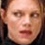 Pixelated close-up of a person's face with neutral expression, visible in static single-frame icon format.