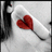A static pixelated image shows a red heart-shaped object on a white curved surface with dark vertical elements on the left and right edges.