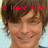 A pixelated close-up of a person with brown hair and light skin smiling, overlaid with red text reading "I love you" against a blurred background.