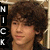 Static pixelated image of a person with curly brown hair, light skin tone, and visible facial features including eyes, nose, mouth, and ears.