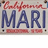 Pixelated California license plate with red 'California' script above blue 'MARI' text and red '1999' below on light background.