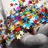 A pixelated animated icon shows a figure with multicolored hair and clothing against a light background, featuring dynamic color shifts in the lower section.