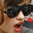A person with brown hair and dark sunglasses has an open mouth expression, with a red 'OMG!' text overlay in the bottom right corner.