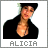 Pixelated image of a person with light skin tone wearing a black top, head tilted slightly right, mouth open in a smile, with the name 'ALICIA' below in gray block letters.
